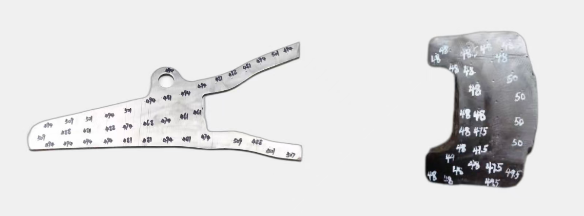 Sectioned Margate adapter and bucket tooth with measured hardness readings marked across the cut face
